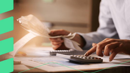 closeup-economist-using-calculator-while-going-through-bills-taxes-office-tiny